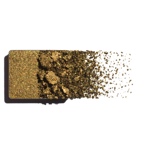 Makeup eyeshadow refill with antique green-gold powder on a white background